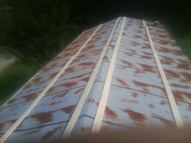 Rusted metal roof panels with new wood purlins before replacement — Storm Damage Roof Repair in Huntertown by Roofing Brothers